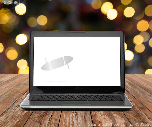 Image of laptop with white screen over christmas lights