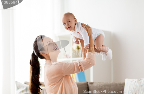 Image of happy mother playing with little baby boy at home