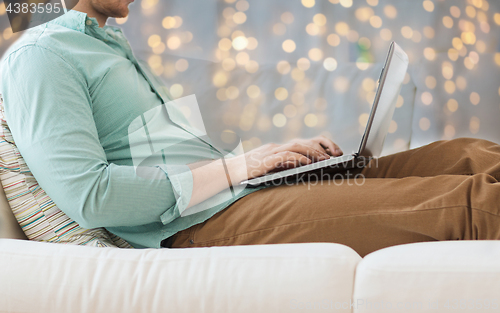 Image of close up of man working with laptop over lights