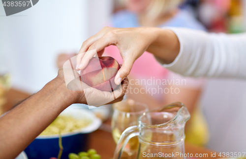 Image of multiracial couple hands with peach