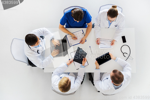 Image of doctors with x-ray and cardiogram at hospital