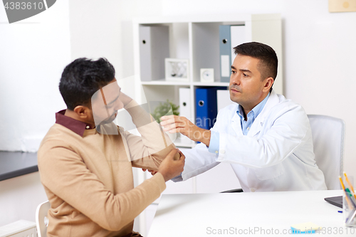 Image of doctor and patient with arm injury at hospital