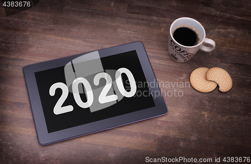 Image of Tablet touch computer gadget on wooden table - 2020