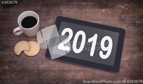 Image of Tablet touch computer gadget on wooden table - 2019