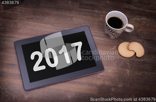 Image of Tablet touch computer gadget on wooden table - 2017