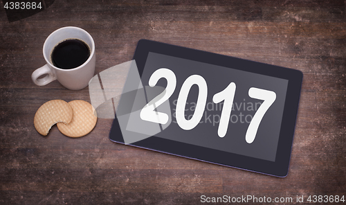 Image of Tablet touch computer gadget on wooden table - 2017