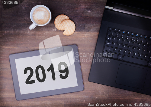 Image of Tablet touch computer gadget on wooden table - 2019