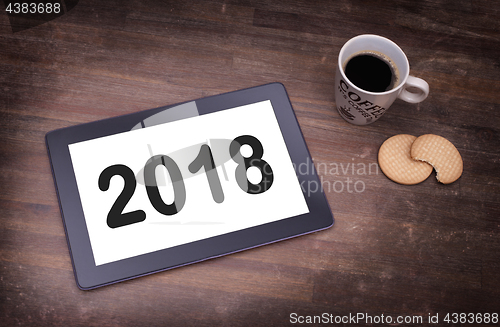 Image of Tablet touch computer gadget on wooden table - 2018