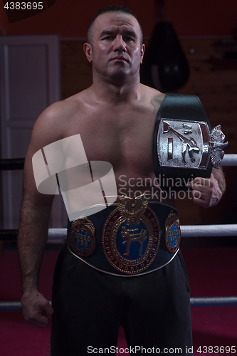 Image of kick boxer with his championship belt