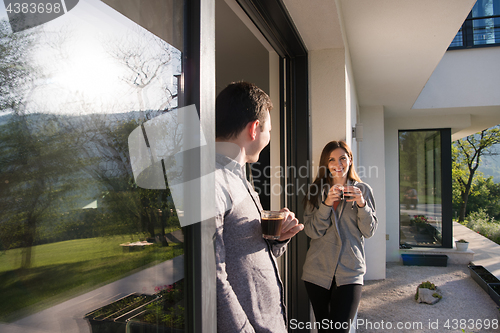 Image of couple enjoying on the door of their luxury home villa