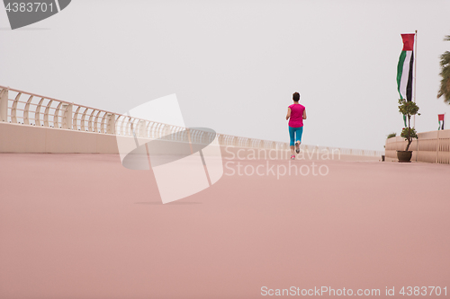 Image of woman busy running on the promenade