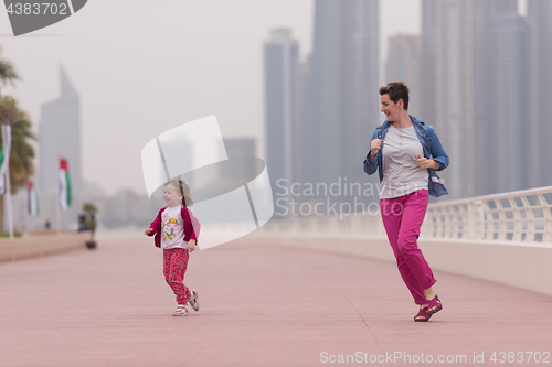 Image of mother and cute little girl on the promenade