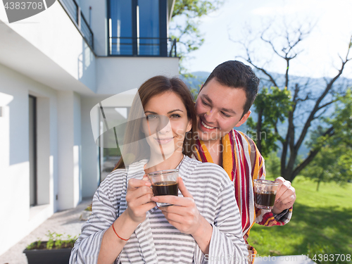 Image of Young beautiful couple in bathrobes