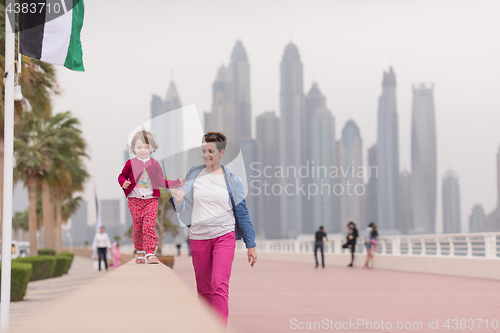 Image of mother and cute little girl on the promenade