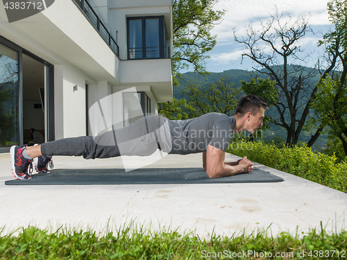 Image of man doing morning yoga exercises