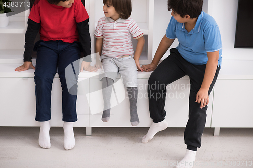 Image of young boys posing on a shelf