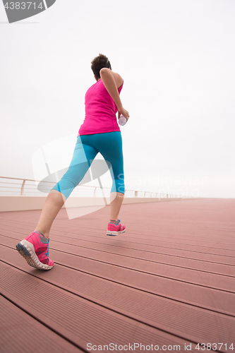 Image of woman busy running on the promenade