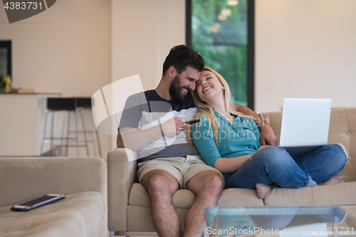 Image of young happy couple relaxes in the living room