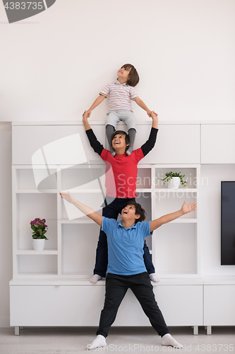 Image of young boys posing line up piggyback