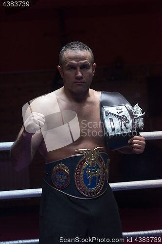 Image of kick boxer with his championship belt