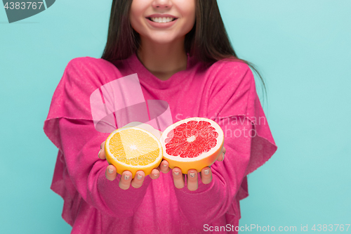 Image of Beautiful woman\'s face with juicy orange