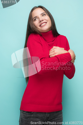 Image of Portrait of happy young woman holding a gift isolated on white