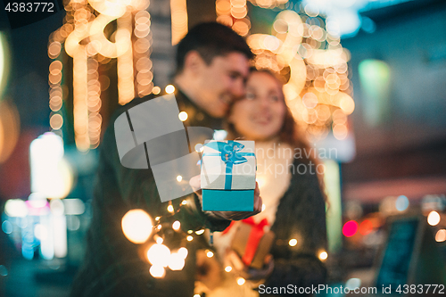 Image of romantic surprise for Christmas, woman receives a gift from her boyfriend