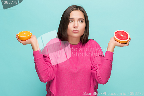 Image of Beautiful woman\'s face with juicy orange