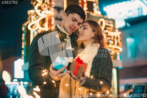 Image of romantic surprise for Christmas, woman receives a gift from her boyfriend