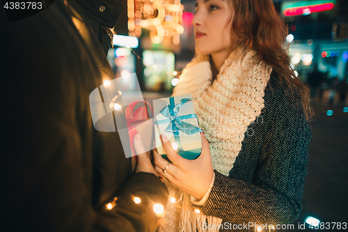 Image of romantic surprise for Christmas, woman receives a gift from her boyfriend