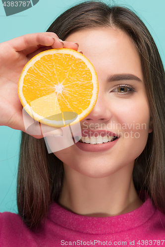 Image of Beautiful woman\'s face with juicy orange