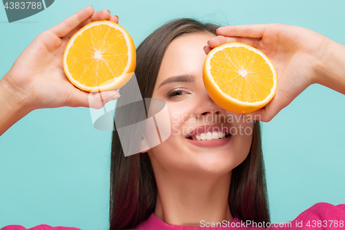 Image of Beautiful woman\'s face with juicy orange