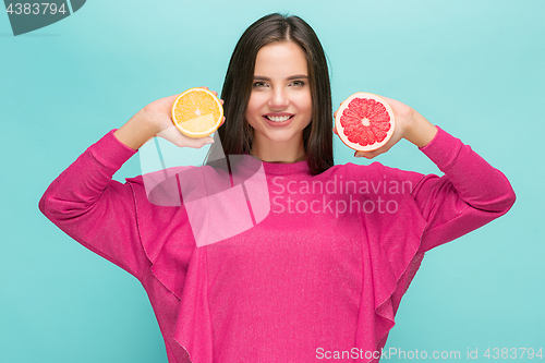 Image of Beautiful woman\'s face with juicy orange