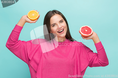 Image of Beautiful woman\'s face with juicy orange