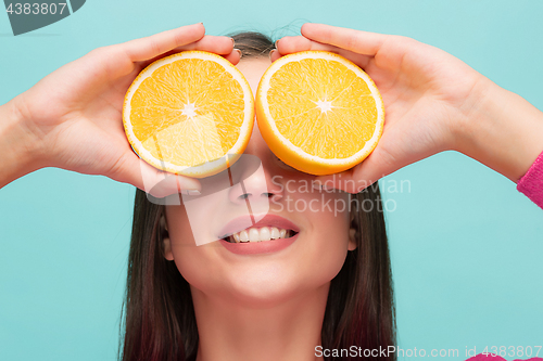 Image of Beautiful woman\'s face with juicy orange