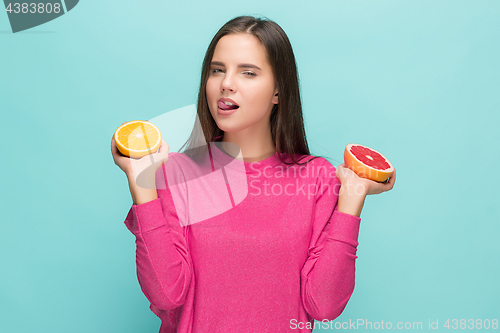 Image of Beautiful woman\'s face with juicy orange