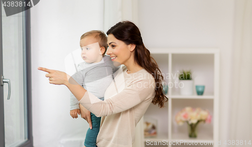 Image of happy mother with little baby boy at home