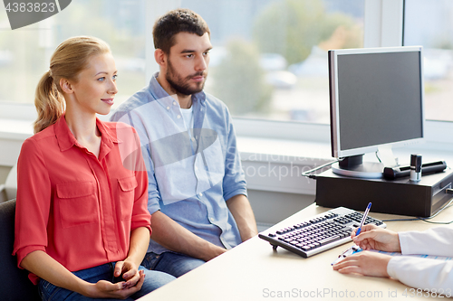 Image of couple visiting doctor at family planning clinic