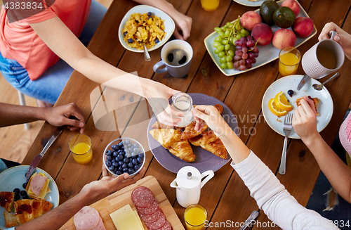 Image of people having breakfast at table with food