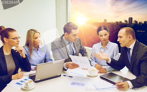 Image of business team with laptop having discussion