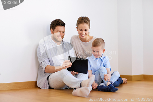 Image of happy family with tablet pc moving to new home