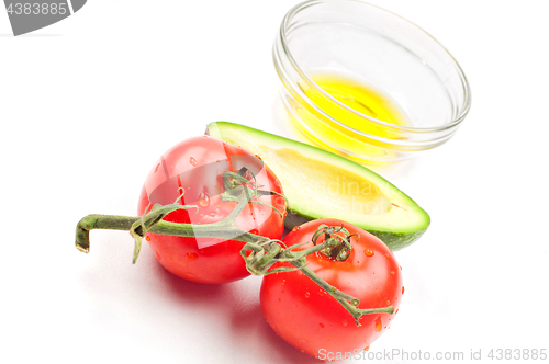 Image of View from above to the tomatoe, avocado, olive oil