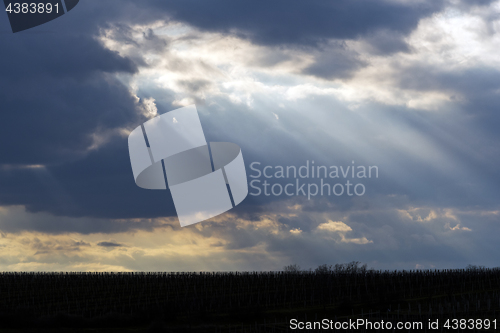 Image of The sun shining through clouds