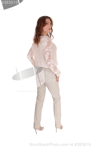 Image of Beautiful woman front the back in trousers