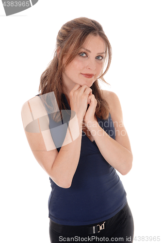 Image of Woman standing with her hands under her chin