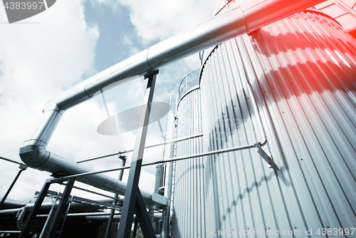 Image of Industrial zone, Steel pipelines and valves against blue sky