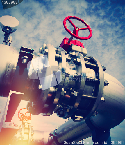 Image of Industrial zone, Steel pipelines and valves against blue sky