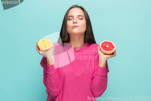 Image of Beautiful woman\'s face with juicy orange