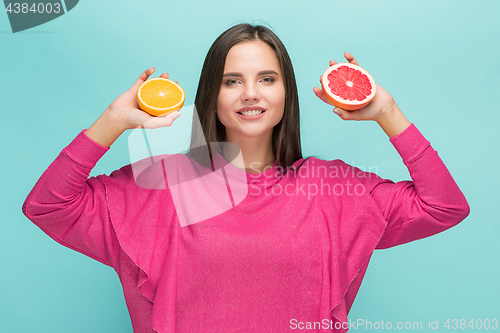 Image of Beautiful woman\'s face with juicy orange