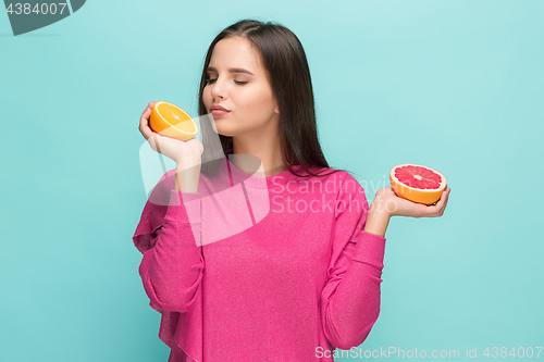 Image of Beautiful woman\'s face with juicy orange